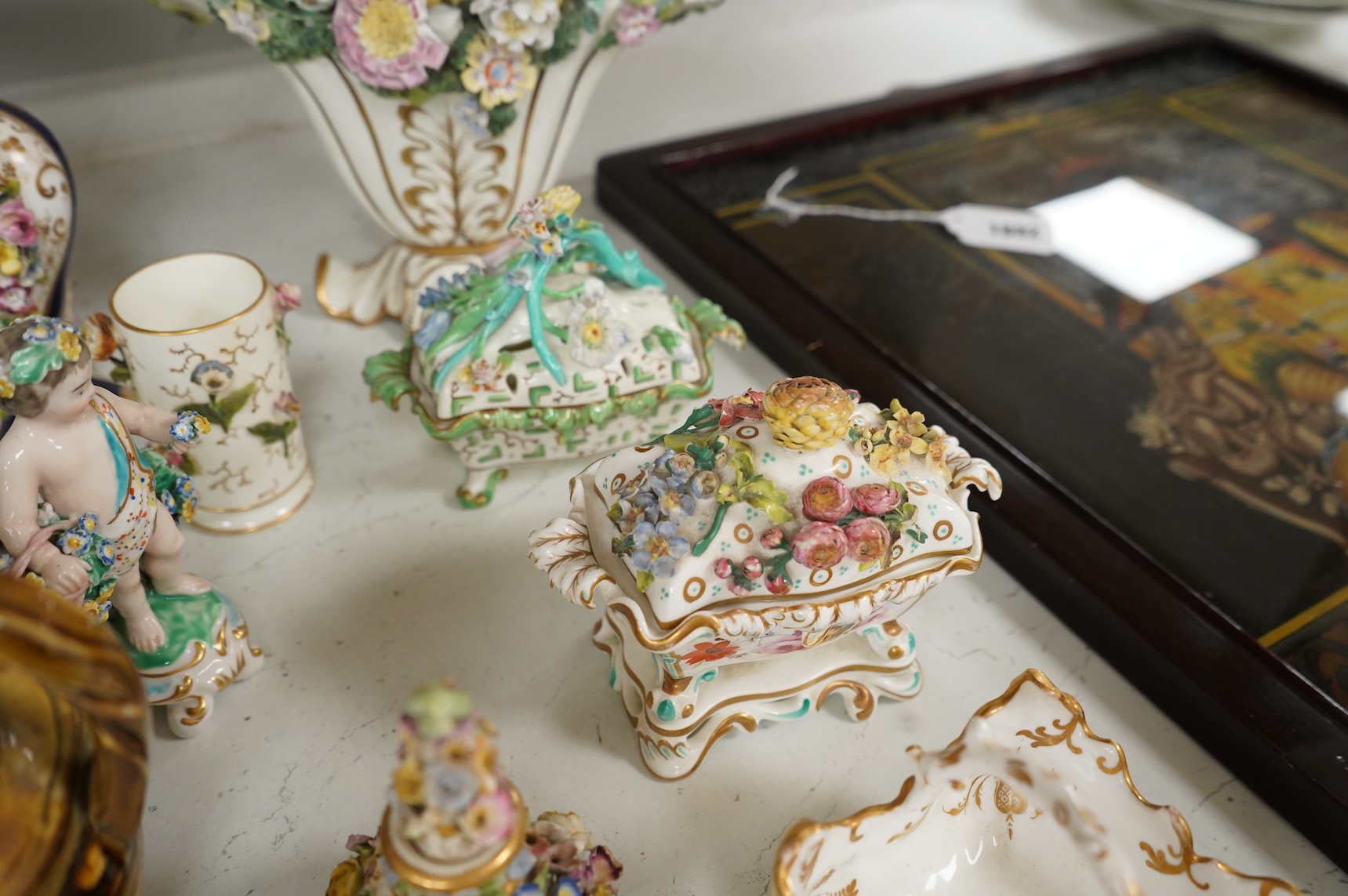 Large group of 19th/20th century English ceramics, to include a Rockingham basket, other English porcelain flower encrusted vessels, a Copeland and Garrett ewer, a Minton Sevres style beaker, a Wedgwood agate ware jug, R